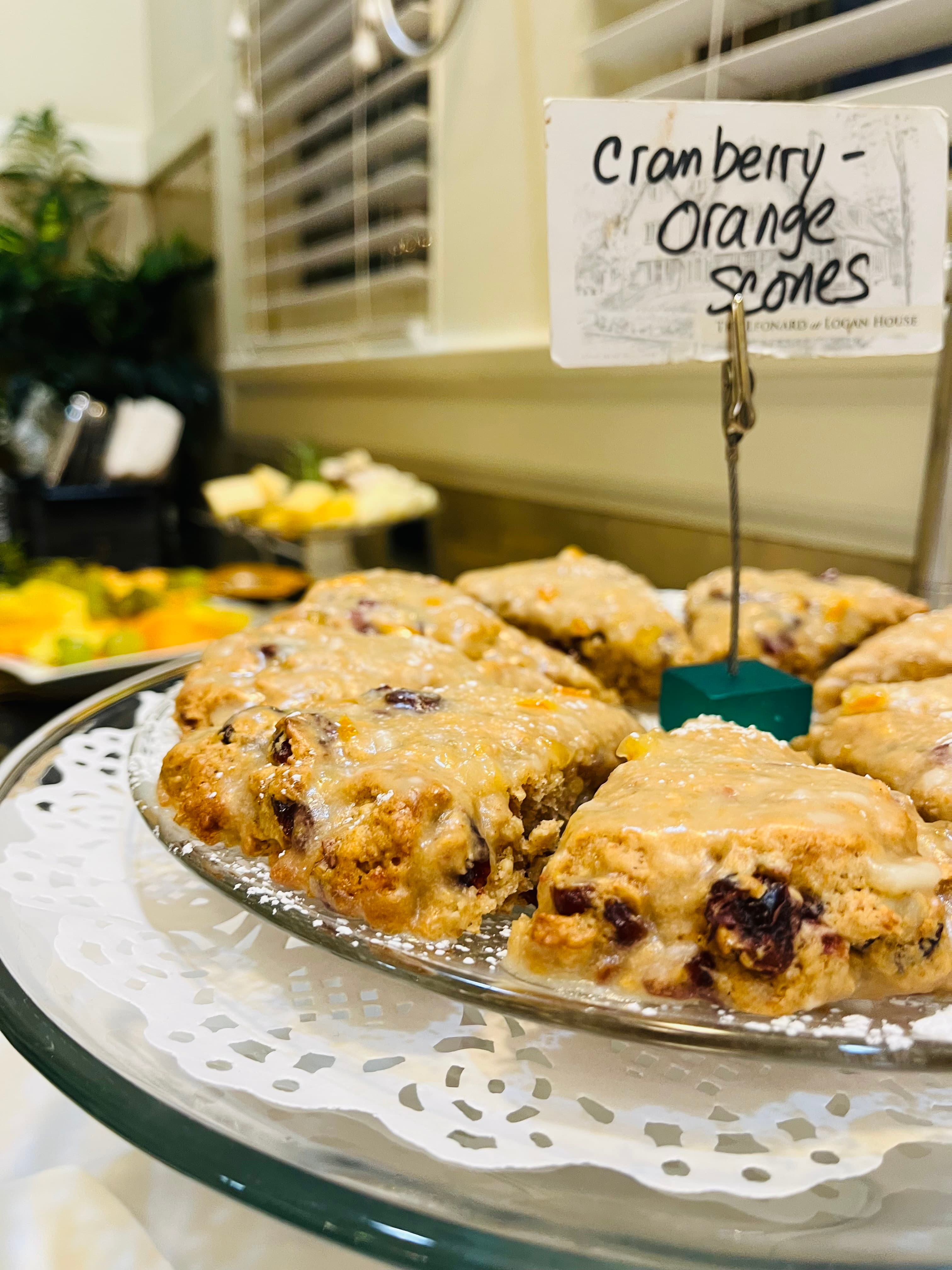 A plate of cranberry-orange scones with a label in the background.